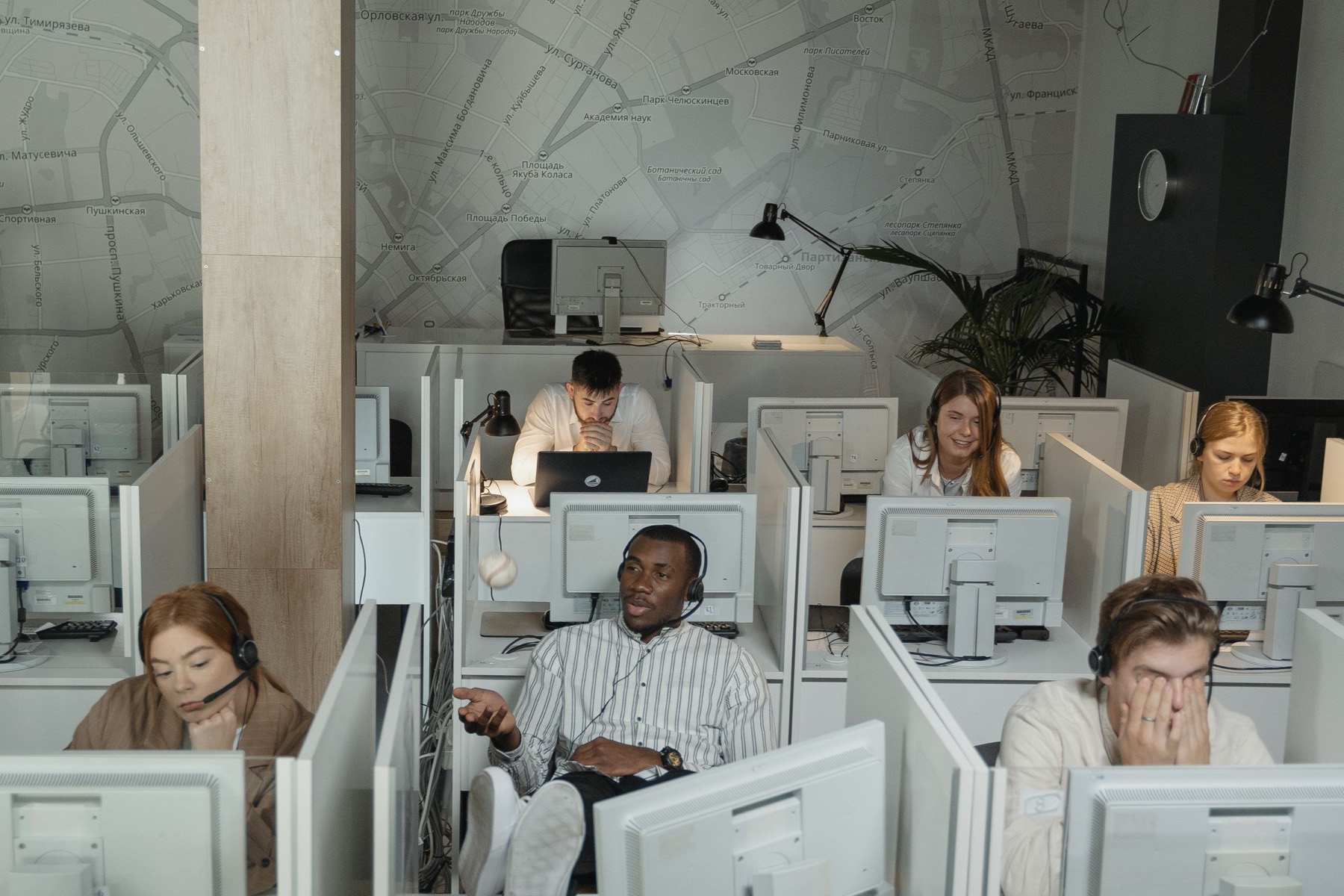 Staff working at computer cubicles across an open operations floor